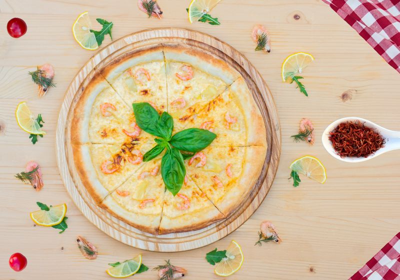 Seafood punch pizza with shrimp calamari and fresh herbs